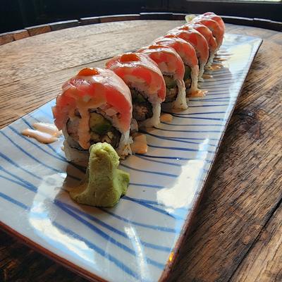 Sushi roll topped with tuna and spicy mayo, with wasabi and ginger on the side